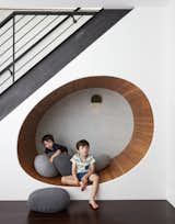 The space below the stairs in this revamped Brooklyn brownstone was turned into a cheerful play area for the clients' two boys. "We built an egg shaped 'nook' underneath the staircase, and filled it with soft ‘pebble’ pillows," adds architect Frederick Tang.