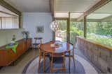 Dining Room, Rug Floor, Storage, Pendant Lighting, Table, and Chair Arranged along a central spine, the Grant House has an open floor plan, a family room, and a kitchen and dining area that merges with a step-down living space.  Photos from Own This L.A. Midcentury by A. Quincy Jones For $2.45M