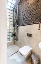 A "steklobloky" wall brightens the bathroom.

  Photo 9 of 16 in Before & After: A Little Flat in Ukraine Gets a Modern Upgrade