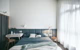 Bedroom, Bed, Chair, Wall Lighting, Floor Lighting, Night Stands, and Medium Hardwood Floor The choice of colors and materials work together to create a bright, cheerful, and romantic atmosphere.

  Photos from A Loft Mezzanine Cleverly Enlarges This Small Beijing Flat