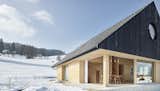 Exterior, House, Gable, Wood, Shingles, Metal, and Cabin The home has warm interiors throughout and boasts a minimalist, cabin-like aesthetic.

  Exterior Metal Cabin Gable Shingles Photos from This Sleek Austrian Home Turns Into a Cozy Light Box at Night