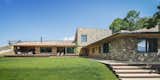 Exterior, Tile Roof Material, Stone Siding Material, House Building Type, and Shed RoofLine The plot slopes downward from street level.   Photos from A Winning Residence in the Spanish Pyrenees Mixes Modern and Rustic
