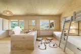 Kids, Pre-Teen, Bench, Bed, Light Hardwood, Bedroom, Bookcase, Neutral, Teen, and Bunks Bunk beds outfit the children's bedroom.  Kids Teen Bench Photos from A Winning Residence in the Spanish Pyrenees Mixes Modern and Rustic