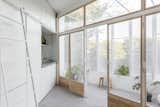 Kitchen, White Cabinet, Concrete Floor, Laminate Counter, and Undermount Sink Glazed, timber-framed folding doors separate the interior living area from the balcony.   Photo 8 of 17 in A Perforated Balcony Brings Ample Light Into a Tiny Abode