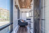 Living Room, Sofa, Recessed Lighting, and Medium Hardwood Floor Stained wood and plenty of large windows give the interiors a warm, bright, and cozy feel.

  Photo 5 of 12 in Grab This Adventure-Ready Tiny Home For Less Than $54K