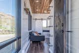 Stained wood and plenty of large windows give the interiors a warm, bright, and cozy feel.

  Photo 5 of 12 in Grab This Adventure-Ready Tiny Home For Less Than $54K