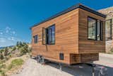 Exterior, Small Home Building Type, Wood Siding Material, Flat RoofLine, and Tiny Home Building Type The exterior is clad in a mixture of stained cedar and shou sugi ban siding.

  Photos from Grab This Adventure-Ready Tiny Home For Less Than $54K