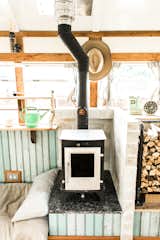The hearth is reinforced inside, and is faced with tiles that look like brick. To the left of the hearth is a wooded storage space.
