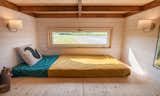 The simple, den-like sleeping nook can easily be converted into a storage space when needed. 