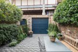Outdoor, Back Yard, Trees, Shrubs, Large Patio, Porch, Deck, Horizontal Fences, Wall, and Stone Patio, Porch, Deck The dark blue, street-side door leads into the garden.  Photo 7 of 14 in A Gorgeous Georgian-Era Dwelling in London Asks $2.2M