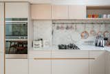 Marble and mosaic tiles are used for the simple, minimalistic kitchen, which includes a larder cupboard.&nbsp;