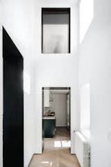 Hallway and Light Hardwood Floor While the apartment's floor area is modest, its high walls give the space a lofty, voluminous feel.  Photo 6 of 14 in A Small Manhattan Home Gains  Space With Two Cozy Lofts