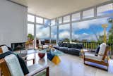 Living, Sofa, Chair, Light Hardwood, Coffee Tables, Corner, Floor, and Lamps The living room encompasses white oakwood floors.

  Living Light Hardwood Lamps Corner Photos from A Vibrant, Iconic Home Hits the Market in Hawaii For $9.8M