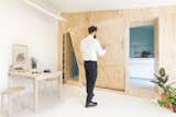 Inside the tiny Batipin Flat in Milan, batipin plywood paneling is used to conceal the kitchen, bathroom, and bed to maximize a sense of spaciousness.&nbsp;&nbsp;