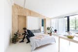 In this tiny Italian apartment, one of the wall panels is a Murphy bed that folds up when not in use.