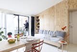 Living, Chair, Stools, Sofa, Table, Table, Shelves, Lamps, Storage, and Linoleum White resin was used for the flooring in the living room.  Living Table Table Sofa Photos from A Tiny Italian Flat Undergoes a Modern Revamp For $40K