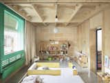 Kids, Toddler, Bedroom, Shelves, Bed, Bookcase, Neutral, Concrete, and Storage The children's bedroom and play area.  Kids Storage Neutral Bed Bookcase Toddler Photos from A Luminous Plywood Addition Crowns This Mallorca Townhouse