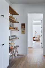 Stools fit nicely under the lowest shelf along the hallway.