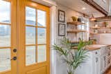 Doors, Exterior, Swing Door Type, and Wood The home boasts a cheery yellow entrance door.  Photo 4 of 10 in This Canadian Tiny Home Beams a Rustic, West Coast Vibe