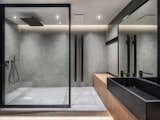 Bath, Vessel, Recessed, Wood, Slate, Open, Enclosed, Full, and Concrete The glass dividers in the bathroom are hand-crafted by Ukrainian craftsmen.  Bath Open Wood Full Vessel Photos from A Monochromatic Palette Unifies Old and New in This Ukrainian Bachelor Pad