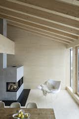 In the living area is a modern, minimalistic concrete fireplace.
