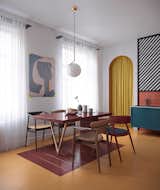 In the dining area sits Finn Juhl 109 chairs, a bespoke table, as well as a chandelier from Flos. There is also a Le Corbusier painting on the wall.