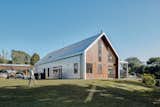 The car port is constructed with the same galvanized metal roof as the house.