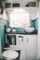 The bathroom walls were painted a rich blue-green to liven up the small space. 