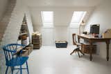 Office, Desk, Chair, Light Hardwood Floor, Study Room Type, Lamps, Storage, and Shelves A peek at the skylit loft office.

  Photos from Before & After: A London Home Doubles as a Cheery Work Space