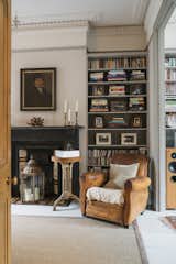 Living, Standard Layout, Chair, Rug, Shelves, Bookcase, Light Hardwood, and Pendant A living lounge with plenty of Victorian character.  Living Rug Chair Light Hardwood Bookcase Photos from Before & After: A London Home Doubles as a Cheery Work Space