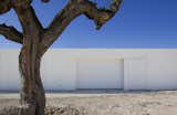 Exterior, Flat RoofLine, and House Building Type An discreet, white garage door.  Photo 4 of 11 in A Minimalist Mediterranean Home Rises in Rural Spain