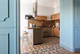 Kitchen, Cooktops, Cement Tile, Marble, Wood, Wood, Accent, Marble, Range Hood, Ceramic Tile, and Undermount Wooden and marble cutting boards by Kaat Collection.  Kitchen Cement Tile Undermount Photos from A Renovated Apartment in an 18th-Century Sicilian Building Pays Homage to the Sea