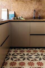 Kitchen, Granite, Undermount, Stone Slab, Ceramic Tile, and Metal In the kitchen the designers paired ancient Sicilian decorated tiles with a refreshed, modern layout.   Kitchen Ceramic Tile Stone Slab Photos from A Renovated Apartment in an 18th-Century Sicilian Building Pays Homage to the Sea