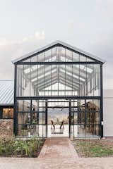 Outdoor, Front Yard, Stone, Gardens, Walkways, and Large In winter, the conservatory is configured to enable solar gain while keeping cold air out. 

  Outdoor Front Yard Large Gardens Photos from A South African Architect Designs an Off-Grid, Modern Home For Her Parents