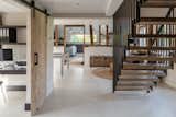 Staircase, Wood Tread, and Metal Railing The steel balustrade of the staircase complements the industrial-style Crittall windows used throughout the house.  Photo 8 of 12 in A Beautifully Renovated Barn House Reveals Rustic Roots in South East England