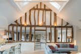 The design team restored the existing wood beams, giving nod to the home’s former rustic life, while introducing big windows, white walls, and clean lines.&nbsp;&nbsp;