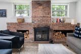 Living Room, Wood Burning Fireplace, Sofa, Coffee Tables, Dark Hardwood Floor, Table Lighting, Standard Layout Fireplace, and Chair The brick on the wood-burning fireplace has been left exposed and offers a striking contrast to the surrounding white walls.
  Photo 4 of 14 in An Updated 1845 Brooklyn Home Hits the Market at $2.95M