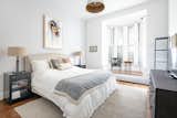 Bedroom, Rug Floor, Table Lighting, Pendant Lighting, Medium Hardwood Floor, Bed, Chair, and Night Stands A look at the master bedroom.  Photo 12 of 14 in An Updated 1845 Brooklyn Home Hits the Market at $2.95M