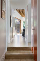 American Oak timber flooring and a built-in sofa add continuity throughout the home.