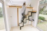 The retractable aluminum staircase can slide into a cabinet when not in use.