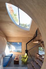 Living Room, Wood Burning Fireplace, Coffee Tables, Bench, Chair, and Concrete Floor Ex of In House by Steven Holl Architects, Interior, Living   Photo 9 of 17 in The Compact, Solar-Powered Ex of In House Sits Lightly Upon the Land