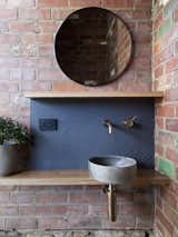 Hobart-based ceramic artist Lindsey Wherrett and Archier collabrated to create the round bathroom sink, whose tones take inspiration from the Mount Wellington undergrowth.&nbsp;