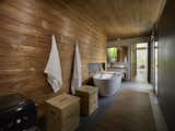 Wooden surfaces give the bathroom and sauna a warm, spa-like feel. A fully glazed wall connects the sauna to the great outdoors.&nbsp;