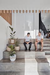 Salvador Farrajota and Brayden Larkin sit on the concrete stairs that lead up to the living areas.