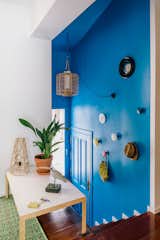 A bright blue stairwell leads up to the living areas.
