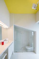 The bathroom can be accessed through an entryway at the back of the bathtub.