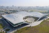 Inspired by the undulating canopy of the region’s banyan trees, the five venues of this performing arts center are located underneath a single, sweeping roof and connected to its parkland site. The National Kaohsiung Center for the Arts rests on a site that formerly hosted a military training base, and represents the city's changing identity.