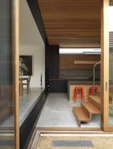 Suntrap House dining area with green concrete floor