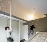 When the directors of London–based Scenario Architecture—husband and wife Ran Ankory and Maya Carni—purchased a Victorian terrace house in London, they sought to renovate, expand, and adapt it to suit the needs of their family of four. The children's bedroom has a climbing wall and a fireman's pole for accessing a special hiding spot in the eave of the historic home.