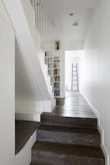 A reading nook is built into one of the walls along the stairs.